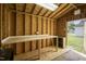 Bright shed interior featuring a worktable and shelving, providing a great space for hobbies and storage at 101 Pine St, Dunn, NC 28334
