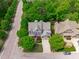 Stunning aerial view of a two-story home with lush landscaping and a private driveway at 103 Woodland Ridge Ct, Cary, NC 27519
