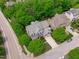Beautiful aerial shot of a home with manicured lawn, mature trees, and a paved driveway at 103 Woodland Ridge Ct, Cary, NC 27519