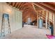 Spacious unfinished attic with exposed wood beams and plywood flooring provides ample storage or expansion potential at 103 Woodland Ridge Ct, Cary, NC 27519