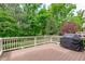 Spacious outdoor deck featuring a grill, perfect for entertaining with a view of the lush greenery at 103 Woodland Ridge Ct, Cary, NC 27519