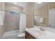 Bathroom featuring a shower-tub combo, vanity with sink, large mirror, and tile flooring at 103 Woodland Ridge Ct, Cary, NC 27519
