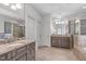 Elegant bathroom with double vanities, granite counters, and a walk-in shower at 103 Woodland Ridge Ct, Cary, NC 27519