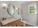 Powder room with a beautiful mirror, vanity, and lighting at 103 Woodland Ridge Ct, Cary, NC 27519