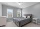 Bedroom with a bed, dresser, and windows providing natural light and views of the outside at 103 Woodland Ridge Ct, Cary, NC 27519