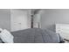 Spacious bedroom with gray walls, a double closet, and a bed with a gray comforter at 103 Woodland Ridge Ct, Cary, NC 27519