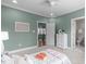 Bright bedroom with a 'Be Happy' sign, leading to bath, and a view of the upstairs landing at 103 Woodland Ridge Ct, Cary, NC 27519