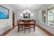 The dining room is the perfect space for entertaining and showcases a lovely chandelier at 103 Woodland Ridge Ct, Cary, NC 27519