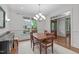 Light-filled dining room with hardwood floors, a chandelier, and large windows offering neighborhood views at 103 Woodland Ridge Ct, Cary, NC 27519