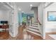 Bright foyer showcasing hardwood floors, white trim, and a staircase to the upper level at 103 Woodland Ridge Ct, Cary, NC 27519