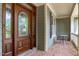 The beautifully designed front door features an oval glass window and is framed by a brick floor at 103 Woodland Ridge Ct, Cary, NC 27519