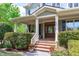 View of the covered porch with brick steps leading to the beautiful front door of this lovely home at 103 Woodland Ridge Ct, Cary, NC 27519