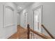 Upstairs hallway with hardwood floors and neutral paint at 103 Woodland Ridge Ct, Cary, NC 27519