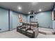 Home theater featuring comfortable leather seating, tiered floor, projector, and recessed lighting for an immersive experience at 103 Woodland Ridge Ct, Cary, NC 27519
