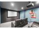 Cozy home theater with comfortable seating, a large screen, and dim lighting for an immersive experience at 103 Woodland Ridge Ct, Cary, NC 27519