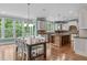 Eat-in kitchen featuring a large dining table, granite countertops, modern appliances and a central island at 103 Woodland Ridge Ct, Cary, NC 27519