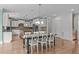 Open kitchen with an island, pendant lighting, hardwood floors, and views of the breakfast nook at 103 Woodland Ridge Ct, Cary, NC 27519