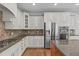 Bright kitchen with stainless steel appliances, including a refrigerator, microwave, and range at 103 Woodland Ridge Ct, Cary, NC 27519