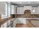 Bright kitchen features granite countertops, white cabinets, and stainless steel appliances at 103 Woodland Ridge Ct, Cary, NC 27519