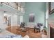 Bright open living room with a fireplace, hardwood floors, second-story landing, and comfortable furniture at 103 Woodland Ridge Ct, Cary, NC 27519