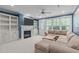 Cozy living room featuring a fireplace, built-in shelving, a comfortable sectional sofa, and ample natural light at 103 Woodland Ridge Ct, Cary, NC 27519