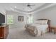 Spacious primary bedroom featuring tray ceiling, and ample light from multiple windows at 103 Woodland Ridge Ct, Cary, NC 27519