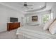 Spacious main bedroom with tray ceiling, dresser, and natural light from multiple windows at 103 Woodland Ridge Ct, Cary, NC 27519