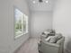Bright sitting room featuring a large window and comfortable armchairs, perfect for relaxation at 103 Woodland Ridge Ct, Cary, NC 27519