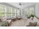 Bright sunroom with lots of windows and comfortable seating at 103 Woodland Ridge Ct, Cary, NC 27519