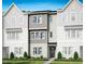 Charming townhome featuring modern architectural details and a well-manicured front lawn at 1043 Zelkova Ln, Chapel Hill, NC 27517