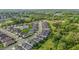 Stunning aerial view of a neighborhood with lush green spaces and a serene lake in the distance at 1047 Aberlour Ln, Burlington, NC 27215
