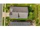An aerial shot exhibits a home with a well-maintained roof, yard and landscaping at 1047 Aberlour Ln, Burlington, NC 27215