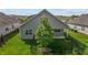 An aerial view of backyard with a patio, tree and a black fence at 1047 Aberlour Ln, Burlington, NC 27215