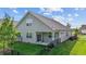 An aerial view shows a home's fenced backyard with a patio, grass and flower beds at 1047 Aberlour Ln, Burlington, NC 27215