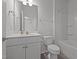 A well-lit bathroom featuring a tiled floor, a single sink vanity, and a shower/tub combo at 1047 Aberlour Ln, Burlington, NC 27215