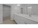 Bright bathroom features a double vanity with a large mirror and a walk-in shower at 1047 Aberlour Ln, Burlington, NC 27215