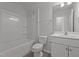 A well-lit bathroom includes a tub, toilet, vanity, and ceramic tile at 1047 Aberlour Ln, Burlington, NC 27215