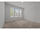 An airy bedroom with carpeted floor and a large window letting in natural light at 1047 Aberlour Ln, Burlington, NC 27215