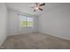 Bright bedroom with carpeted floors, a ceiling fan, and a window with views of the outside at 1047 Aberlour Ln, Burlington, NC 27215