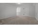 A brightly lit bonus room with multiple entrances, carpet, and neutral wall colors at 1047 Aberlour Ln, Burlington, NC 27215