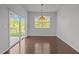 Bright dining area features hardwood floors, sliding glass doors, and decorative hanging light fixture at 1047 Aberlour Ln, Burlington, NC 27215