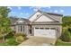 Charming house with a stone facade, attached garage, and manicured landscaping at 1047 Aberlour Ln, Burlington, NC 27215