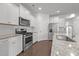 Modern kitchen with white cabinetry, stainless steel appliances, and granite countertops at 1047 Aberlour Ln, Burlington, NC 27215