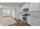Well-lit kitchen with white cabinets, stainless steel appliances, and granite countertops at 1047 Aberlour Ln, Burlington, NC 27215