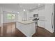 Open-concept kitchen with a large island, granite countertops, and stainless steel appliances at 1047 Aberlour Ln, Burlington, NC 27215