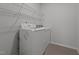 A well-lit laundry room featuring updated appliances and ample storage space at 1047 Aberlour Ln, Burlington, NC 27215
