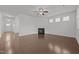 Spacious living room with hardwood floors, a fireplace, and open access to other areas at 1047 Aberlour Ln, Burlington, NC 27215
