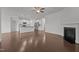 Open-concept living space featuring wood floors, a fireplace, and a seamless transition to the kitchen at 1047 Aberlour Ln, Burlington, NC 27215