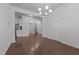 Open living room featuring hardwood floors, neutral walls, and a view of the staircase and kitchen at 1047 Aberlour Ln, Burlington, NC 27215