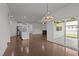Open concept living space with hardwood floors, a modern fireplace, and sliding glass doors to the patio at 1047 Aberlour Ln, Burlington, NC 27215